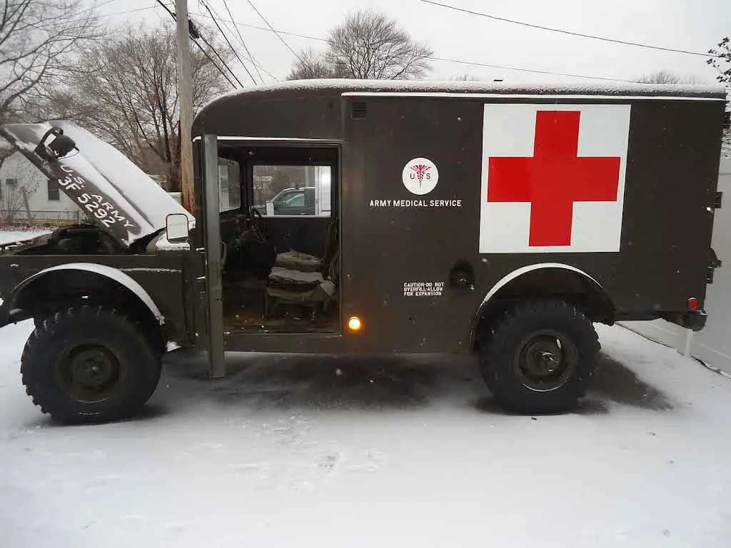 Vintage military ambulance truck parked in the snow