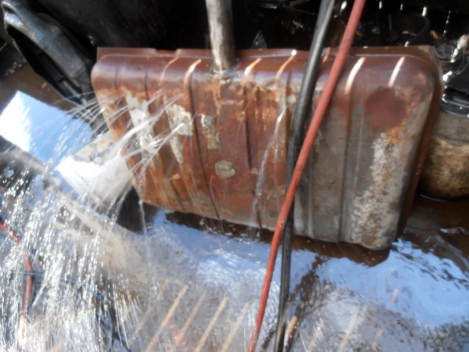 This Chevelle gas tank would've been more useful as a lawn sprinkler before we coated it with Red Kote